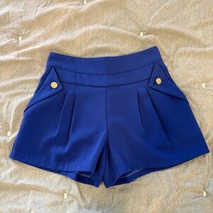Stylish Blue Pleated Shorts with Gold Button Accents